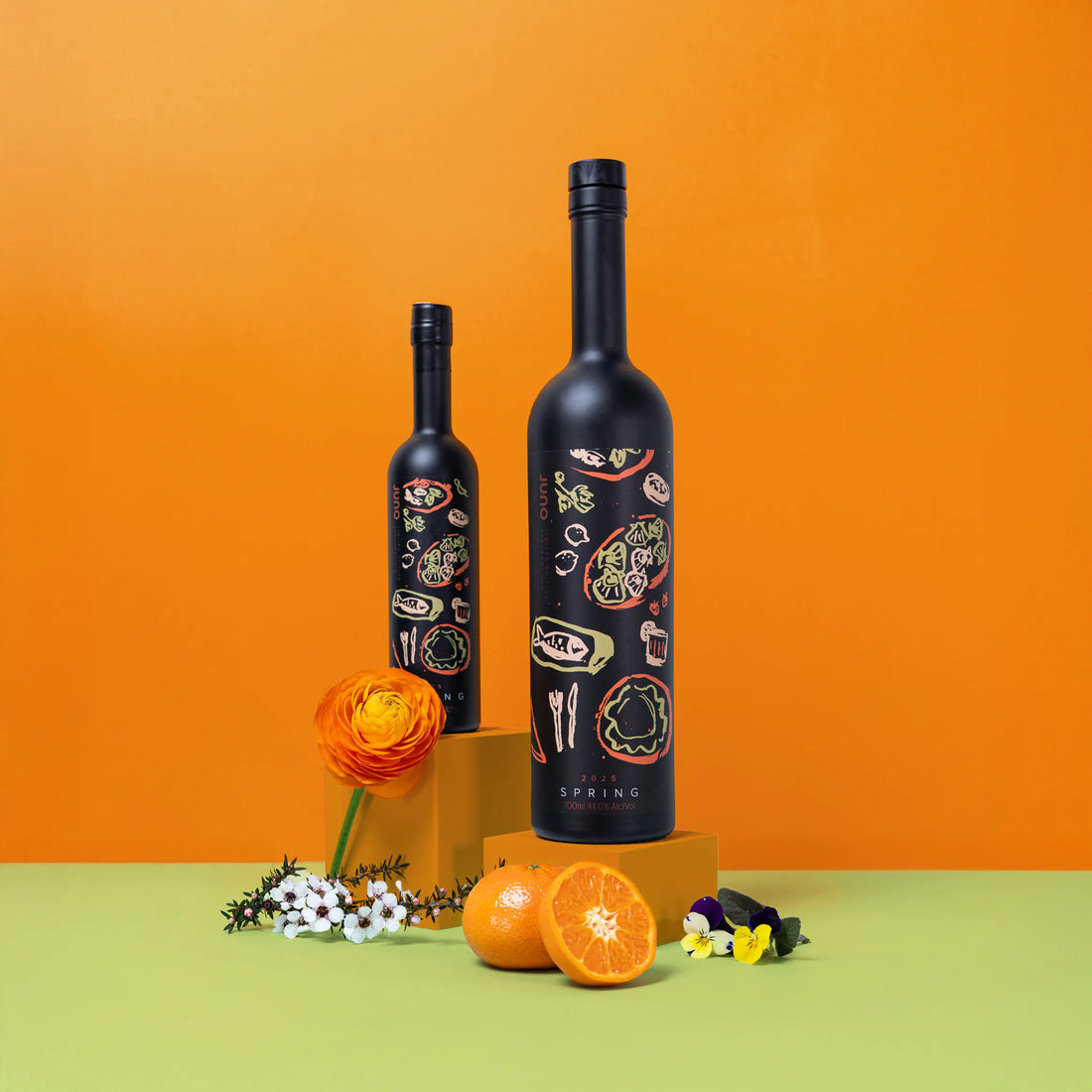Two bottles of Spring 2025 Seasonal Gin against an orange background