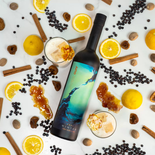 A bottle of Winter 2024 Seasonal gin with spices and lemons