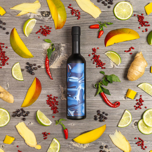 A bottle of Summer 2024 Seasonal Gin with mangos and chillis