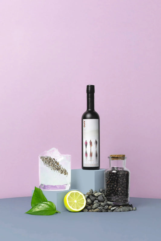 An On the Beach cocktail with a bottle of Juno Winter 2025 Seasonal Gin