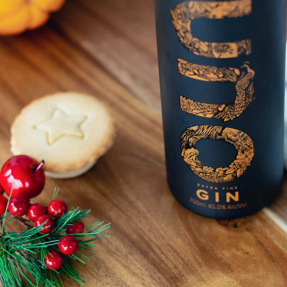 A bottle of Juno Extra Fine Gin and a mince pie