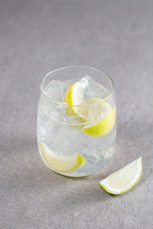 A Goddess and Saint cocktail in a short glass with lime wedge garnish