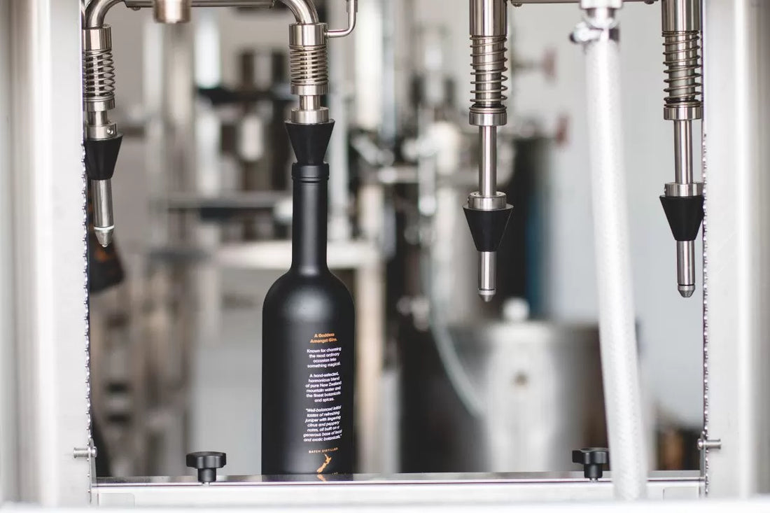 A bottle of Juno Extra Fine Gin on the silver bottle-filling machine