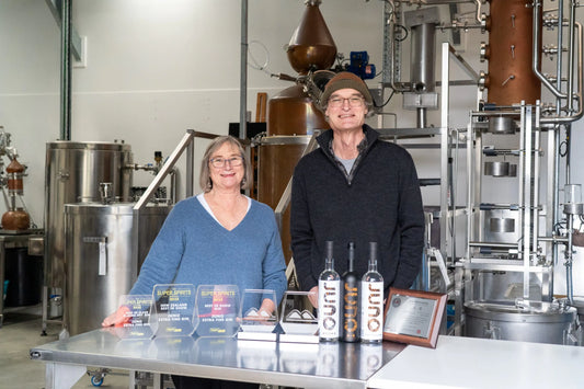 Jo and Dave with their trophies in front of Lila the copper still