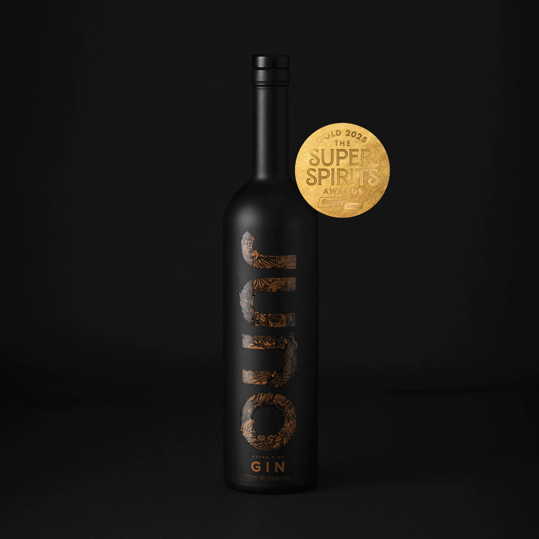 A bottle of Juno Extra Fine Gin with a medal